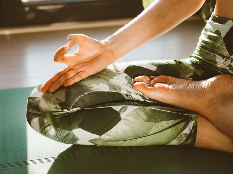 Close up of hands moving fluidly during yoga session.